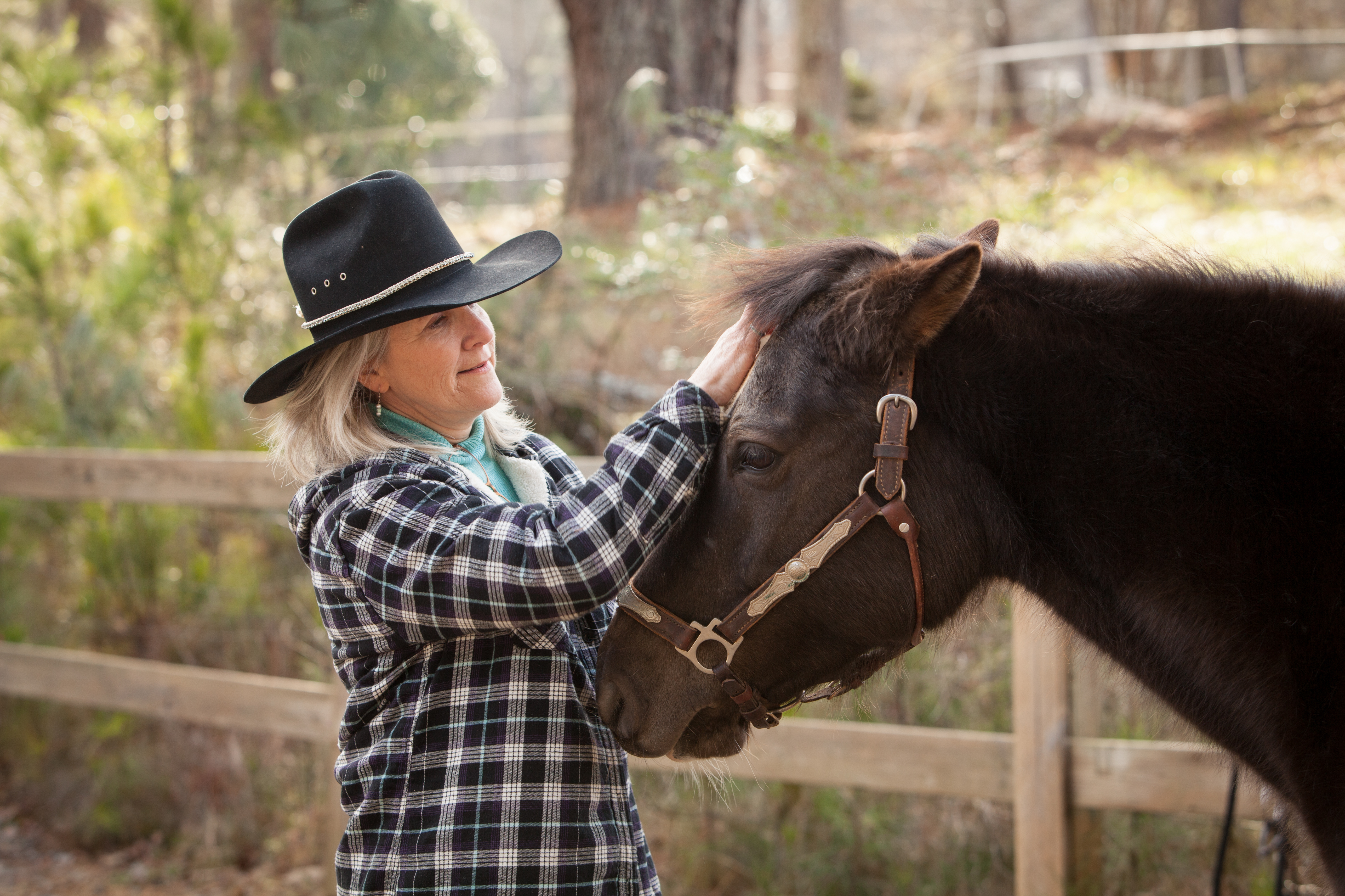 Tammy Largin petting her horse